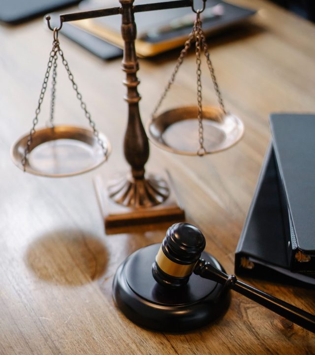 High angle lawyers desk with decorative judgement scales and gavel in modern law firm
